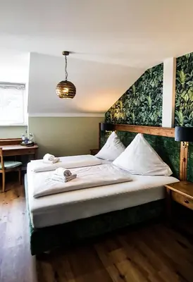 Ein Bett oder Betten in einem Zimmer der Unterkunft Hotel Schmiedhubers