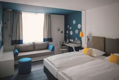 Ein Bett oder Betten in einem Zimmer der Unterkunft Vienna House Easy by Wyndham Landsberg
