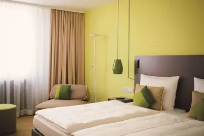 Ein Bett oder Betten in einem Zimmer der Unterkunft Vienna House Easy by Wyndham Landsberg