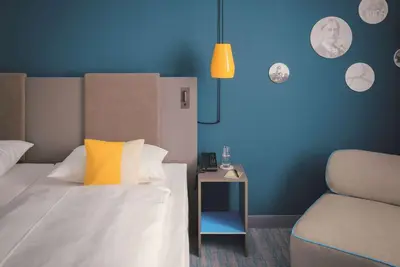 Ein Bett oder Betten in einem Zimmer der Unterkunft Vienna House Easy by Wyndham Landsberg