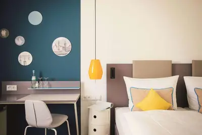Ein Bett oder Betten in einem Zimmer der Unterkunft Vienna House Easy by Wyndham Landsberg