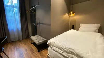 Ein Bett oder Betten in einem Zimmer der Unterkunft Munich Rooms Hotel