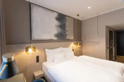 Ein Bett oder Betten in einem Zimmer der Unterkunft Munich Rooms Hotel