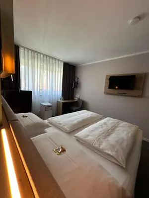 Ein Bett oder Betten in einem Zimmer der Unterkunft Hotel Rappensberger