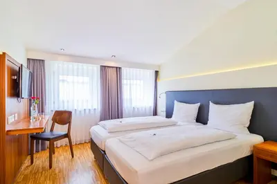 Ein Bett oder Betten in einem Zimmer der Unterkunft Hotel Apfelbaum