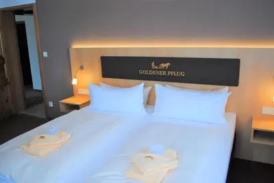 Ein Bett oder Betten in einem Zimmer der Unterkunft Landgasthof Goldener Pflug