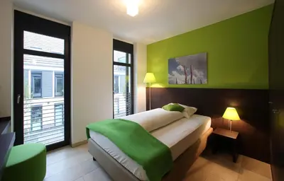 Ein Bett oder Betten in einem Zimmer der Unterkunft KH Hotel