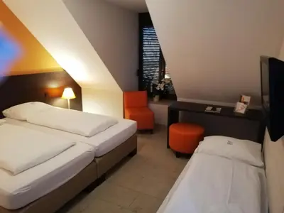 Ein Bett oder Betten in einem Zimmer der Unterkunft KH Hotel