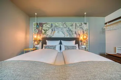 Ein Bett oder Betten in einem Zimmer der Unterkunft Vienna House Easy by Wyndham Augsburg