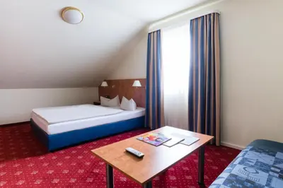 Ein Bett oder Betten in einem Zimmer der Unterkunft Hotel St. Georg