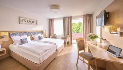 Ein Bett oder Betten in einem Zimmer der Unterkunft Ströbinger Hof - Therme Wellness Resort