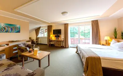Ein Bett oder Betten in einem Zimmer der Unterkunft Ströbinger Hof - Therme Wellness Resort