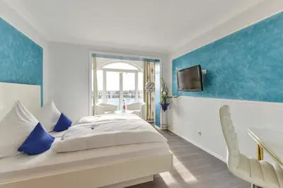 Ein Bett oder Betten in einem Zimmer der Unterkunft Bavaria Hotel