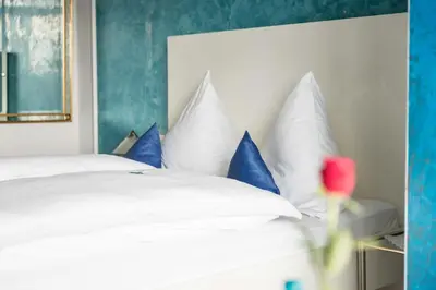 Ein Bett oder Betten in einem Zimmer der Unterkunft Bavaria Hotel