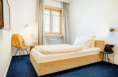 Ein Bett oder Betten in einem Zimmer der Unterkunft Alpenrose Bayrischzell Hotel