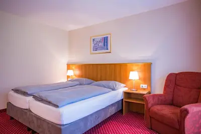 Ein Bett oder Betten in einem Zimmer der Unterkunft Hotel Friedenseiche