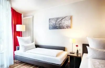 Ein Bett oder Betten in einem Zimmer der Unterkunft Leonardo Hotel Muenchen City West