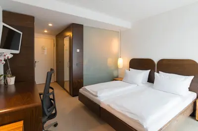 Ein Bett oder Betten in einem Zimmer der Unterkunft Corbin München Airport Business Hotel