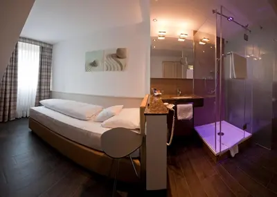 Ein Bett oder Betten in einem Zimmer der Unterkunft Hotel Lechnerhof Unterföhring