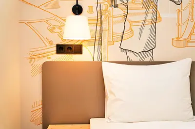 Ein Bett oder Betten in einem Zimmer der Unterkunft McDreams Hotel München-Nord