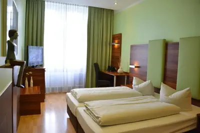 Ein Bett oder Betten in einem Zimmer der Unterkunft Arthotel Munich