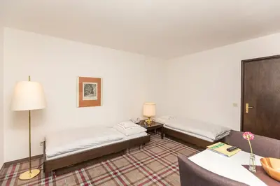 Ein Bett oder Betten in einem Zimmer der Unterkunft Hotel Alpenhof Postillion