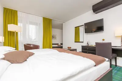 Ein Bett oder Betten in einem Zimmer der Unterkunft Hotel Alpenhof Postillion
