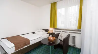 Ein Bett oder Betten in einem Zimmer der Unterkunft Hotel Alpenhof Postillion