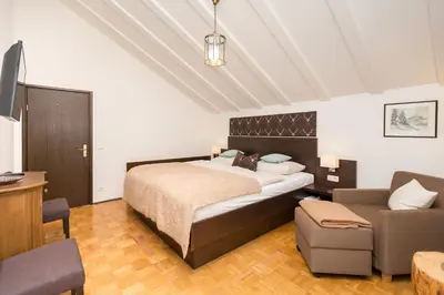 Ein Bett oder Betten in einem Zimmer der Unterkunft Hotel Alpenhof Postillion
