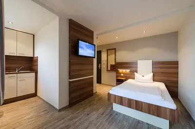 Ein Bett oder Betten in einem Zimmer der Unterkunft Central Hotel-Apart München