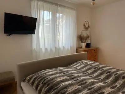 Ein Bett oder Betten in einem Zimmer der Unterkunft ALPEN WOHLFÜHLQUARTIER