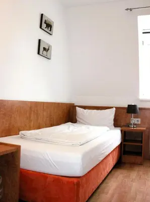 Ein Bett oder Betten in einem Zimmer der Unterkunft Hotel Waitzingers