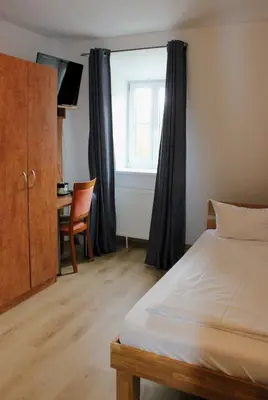 Ein Bett oder Betten in einem Zimmer der Unterkunft Hotel Waitzingers