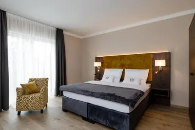 Ein Bett oder Betten in einem Zimmer der Unterkunft Herzl Hotel bei Erding