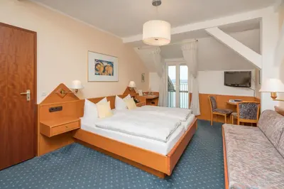 Ein Bett oder Betten in einem Zimmer der Unterkunft Seehotel Grauer Bär