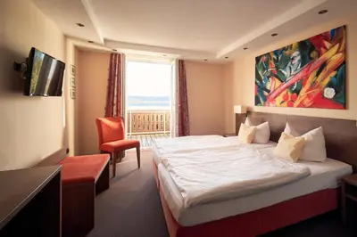 Ein Bett oder Betten in einem Zimmer der Unterkunft Seehotel Grauer Bär