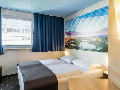 Ein Bett oder Betten in einem Zimmer der Unterkunft B&B Hotel München City-Nord