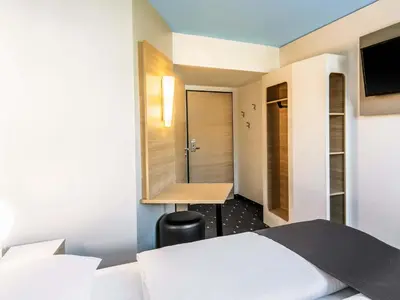 Ein Bett oder Betten in einem Zimmer der Unterkunft B&B Hotel München City-Nord