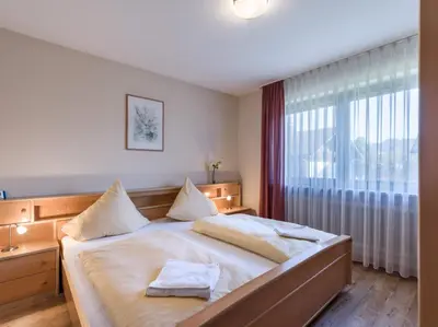 Ein Bett oder Betten in einem Zimmer der Unterkunft Ferienwohnanlage Oberaudorf C4 mit Hallenbad und Sauna