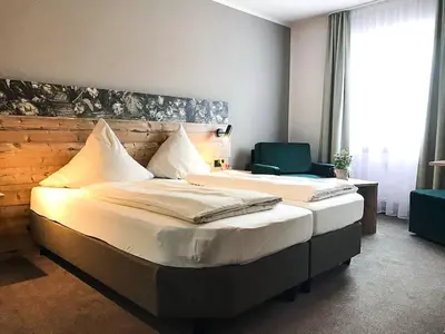 Ein Bett oder Betten in einem Zimmer der Unterkunft Hotel Häußler
