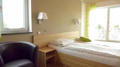 Ein Bett oder Betten in einem Zimmer der Unterkunft Hotel Fränkischer Hof