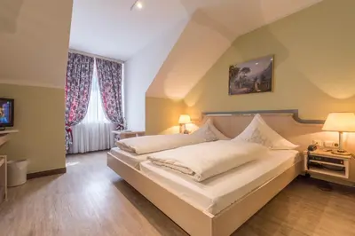 Ein Bett oder Betten in einem Zimmer der Unterkunft Hotel am Schlosspark