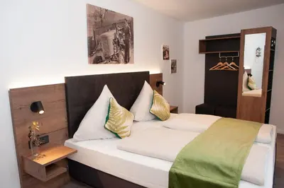 Ein Bett oder Betten in einem Zimmer der Unterkunft Gasthaus Stöttnerbräu