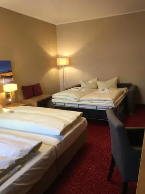 Ein Bett oder Betten in einem Zimmer der Unterkunft Parkhotel Leiser