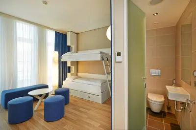 Ein Bett oder Betten in einem Zimmer der Unterkunft H2 Hotel München Messe