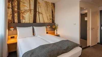 Ein Bett oder Betten in einem Zimmer der Unterkunft Holiday Inn Munich - Leuchtenbergring by IHG