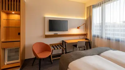 Ein Bett oder Betten in einem Zimmer der Unterkunft Holiday Inn Munich - Leuchtenbergring by IHG