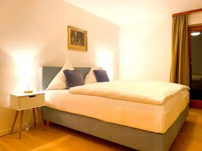 Ein Bett oder Betten in einem Zimmer der Unterkunft Apartmenthaus am Tegernsee - Studios mit Küchenzeile und mit Bus erreichbar