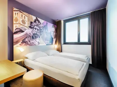 Ein Bett oder Betten in einem Zimmer der Unterkunft B&B Hotel Augsburg-West