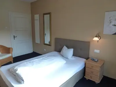 Ein Bett oder Betten in einem Zimmer der Unterkunft Alpenhof Landhotel Restaurant